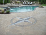 Poolside patio with inset compass rose and plantings add elegance